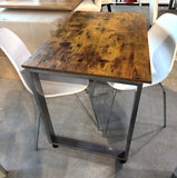 3-piece dining set – rustic brown wood-grain table on silver metal U-frame with 2 white chairs, end view
