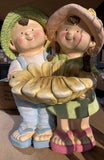 Boy and girl holding sunflower birdbath garden statue