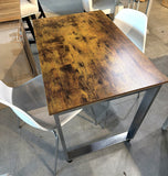 High-angle view of the rustic brown dining table with 2 white molded chairs