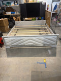 King bed frame with mirrored upholstered footboard – angled view showing wood slats and side rails