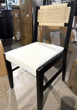 Black and white wicker back dining chair, front view showing missing front footrest