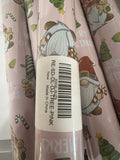 Pink Christmas wrapping paper roll with gnomes – label close-up