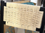 Woven natural paper-rope back detail on black wood dining chair