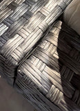 Close-up of the gray/charcoal multi-tone PE wicker weave on the arm