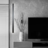 Minimalist black LED long strip wall lamp, 100cm – reference image (similar model), by a TV wall