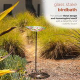 Alpine 10 inch glass stake birdbath with flowers and hummingbird – in the garden, side view