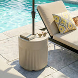 Beige 90 lb patio umbrella base holding a patio umbrella beside a poolside lounger