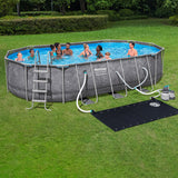 Bestway Platinum Series Power Steel 20 x 12 ft x 48 in oval above ground pool set – set up in a backyard with ladder, sand filter pump and solar heater (stock photo)