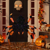 Lighted spider Halloween décor lit on a porch with purple LEDs – lifestyle view