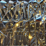 Close-up of the gold foil-wrapped frame and warm white LED fairy string lights on the Alpine DXP114 reindeer