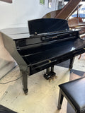 Kohler digital grand piano in polished ebony with lid closed – front angle