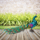Jumbo blue majestic tail-down peacock garden statue on a wooden deck – lifestyle view
