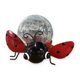 Solar ladybug garden statue with crackle glass globe – front view on white