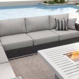 Sirio Soho modular outdoor sectional, charcoal woven resin wicker with taupe Sunbrella cushions – shown set up by a pool (stock photo; fire table sold separately; stock cushion color may look different)