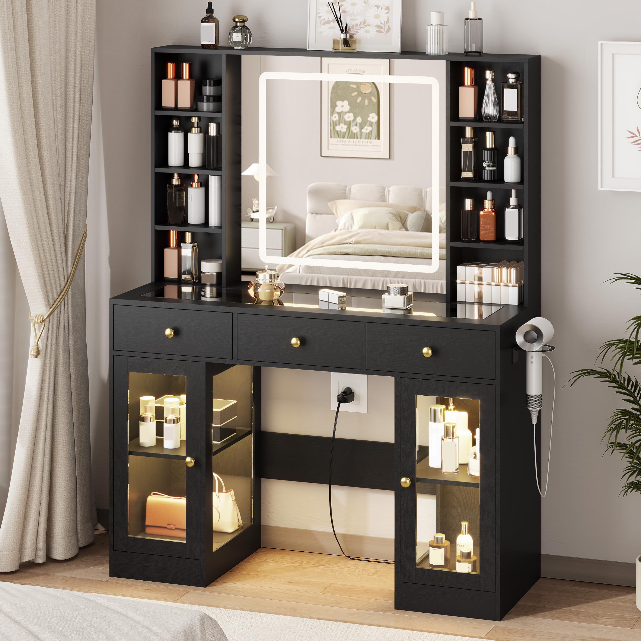 Black vanity desk with lighted mirror and lit glass cabinets – front view in a bedroom (manufacturer image)