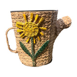 Woven watering can planter with raised yellow sunflower, spout and side handle – real photo on white