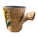 Woven watering can planter – side view showing the woven spout and sunflower, real photo on white